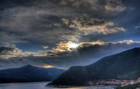 Photography Of Mountain Near The Body Of Water In Golden Hour Last