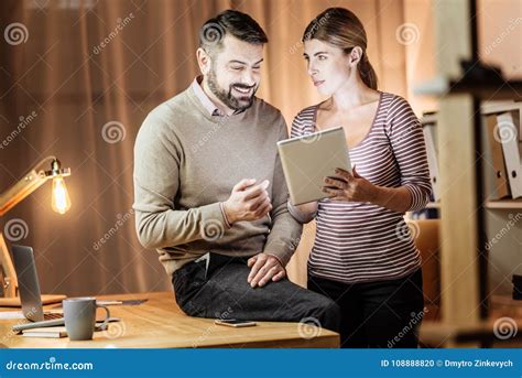 Positive Delighted Man Communicating With His Colleague Stock Photo