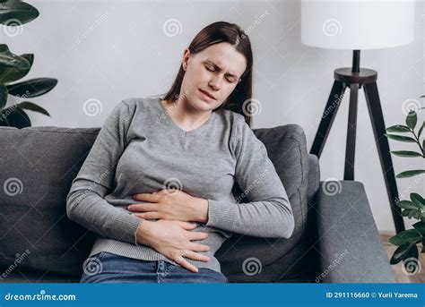 Upset Sad Woman Holding Belly And Feeling Abdominal Menstrual Pain Or Bowel And Digestion