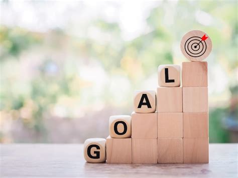 Premium Photo Wooden Blocks With The Word GOAL And Business Strategy