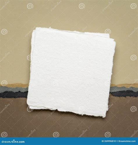 Small Square Sheet Of Blank White Paper Against Abstract In Earth Tones