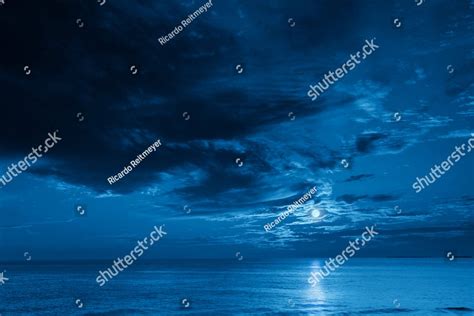 This Photo Illustration Of A Deep Blue Moonlit Ocean And Sky At Night