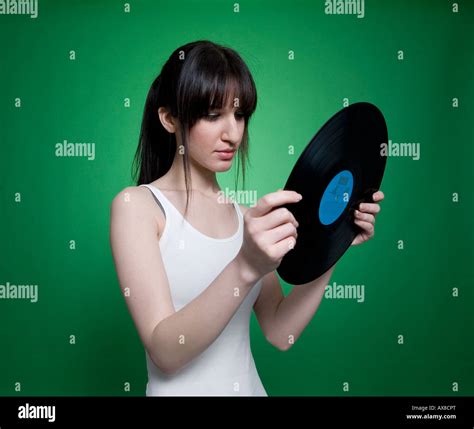 A Girl Looking At A Vinyl Record Stock Photo Alamy