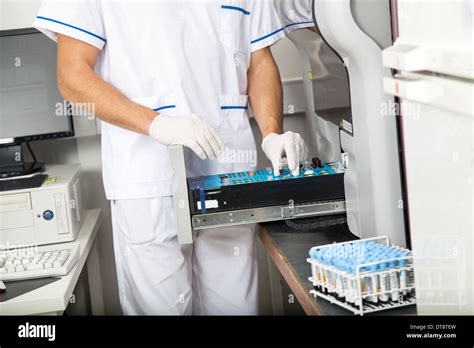 Scientist Loading Samples Into Analyzer Stock Photo Alamy