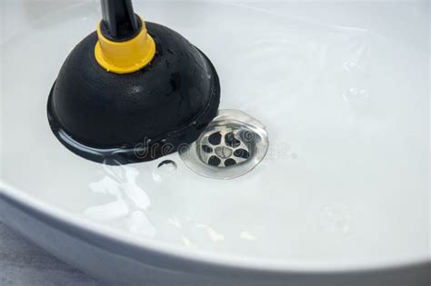 Plunger and clogged sink stock photo. Image of plunger - 238627712