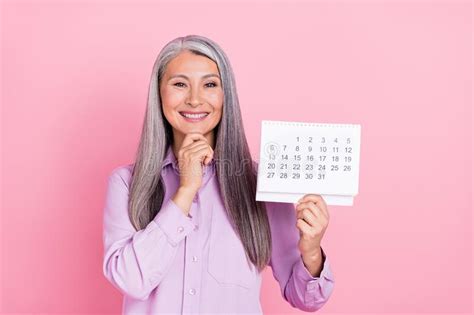 Portrait Of Attractive Glad Cheerful Gray Haired Woman Holding Calendar