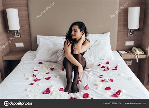 Sexy Brunette Girl Black Stockings Sitting Bed Rose Petals Bedroom Stock Photo By IgorVetushko