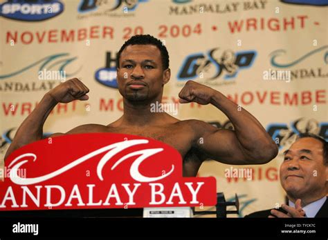 Sugar Shane Mosley shows off his muscles as he weighs in at 154 pounds for his November 20 title ...