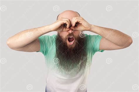 Portrait Of Shocked Middle Aged Bald Man With Long Beard In Light Green