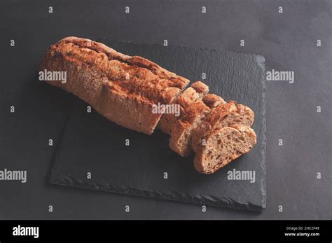 Fresh Crispy French Baguette On A Black Stone Background Wrapping