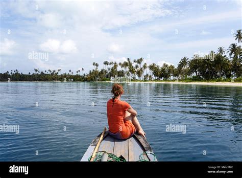 Attractive Woman In Orange Dress Sitting On Top Of The Boat Cruising In