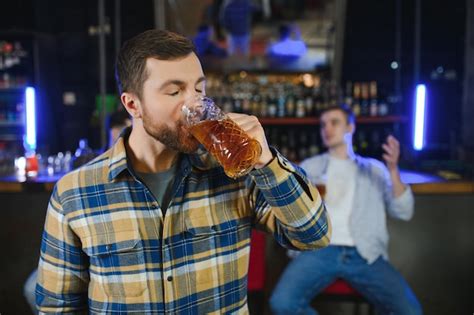 Premium Photo Night In Bar Portrait Of Cheerful Men Drinking Beer At