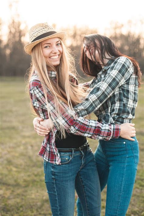 Two Young Women Having Fun On The Field Stock Image Image Of Sitting