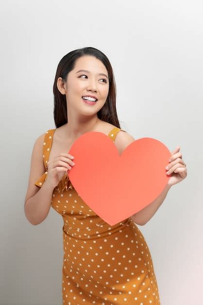 Premium Photo Portrait Of Attractive Asian Smiling Woman Holding Red