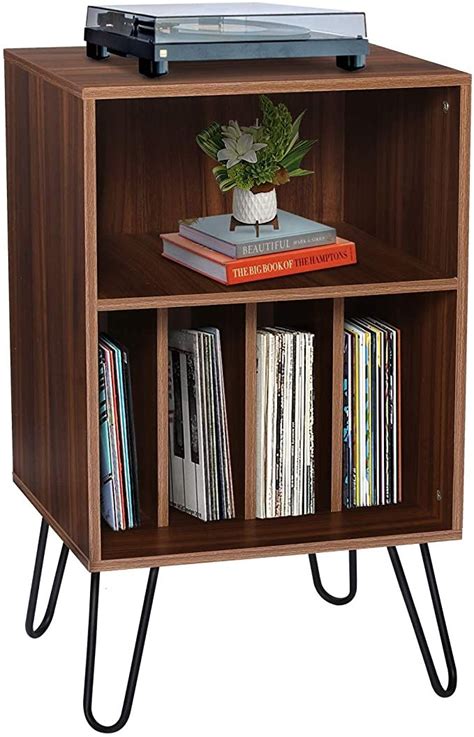 A Wooden Shelf With Some Books And A Remote Control On It S Side Table