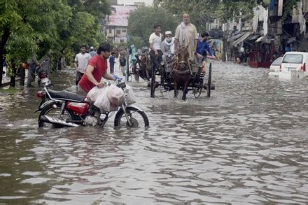 Pakistani Commuters Wade Through Flooded Road Editorial Stock Photo