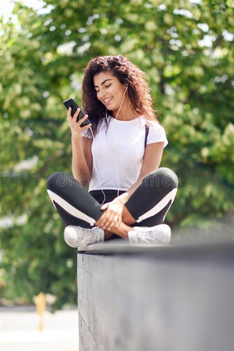 African Woman Listening To Music With Earphones And Smart Phone Stock