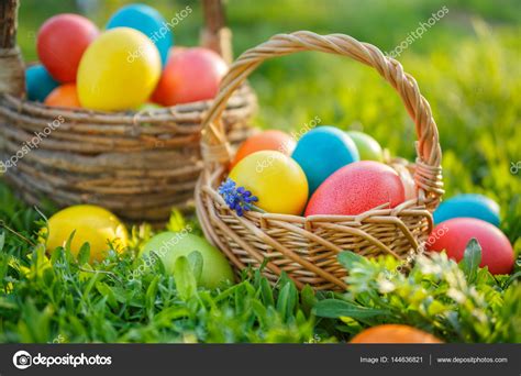 Colorful Easter Eggs In Baskets On The Spring The Grass Stock Photo