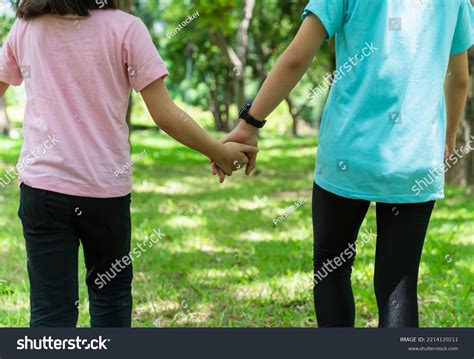 2 Sisters Holding Hands