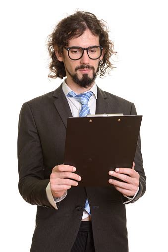 Handsome Businessman Reading Clipboard While Wearing Eyeglasses Stock