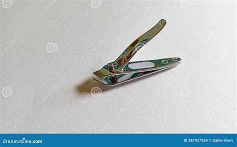 Elegant Steel Nail Clippers With A Pointed Tip Placed On A Clean White