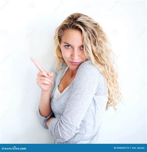 Woman Portrait And Pointing Finger Playful Or Flirt Fun White Wall