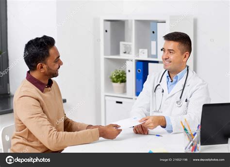 Doctor And Male Patient Meeting At Clinic Stock Photo By ©syda