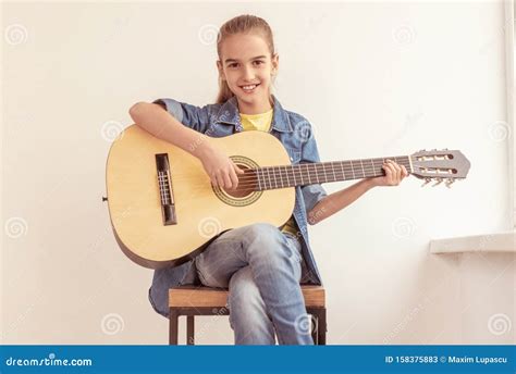 Cheerful Girl Playing Guitar On Stool Stock Image Image Of Girl Play