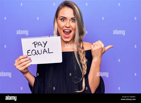 Beautiful Blonde Woman Asking For Equality Economy Holding Paper With Pay Equal Message Pointing
