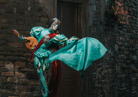 A Person in Green Costume Standing on the Street · Free Stock Photo