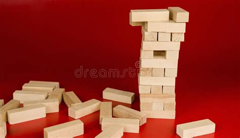 Jenga Game On Red Background Tower Of Small Wooden Blocks Play Board