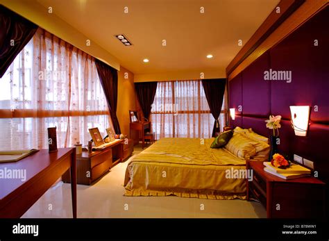 A furnished bedroom with cupboards and tables Stock Photo - Alamy