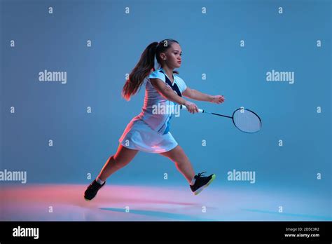 High Up Beautiful Dwarf Woman Practicing In Badminton Isolated On Blue