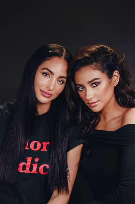 two beautiful young women sitting next to each other