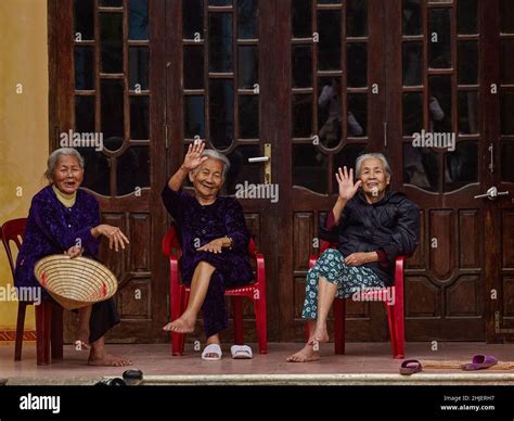 Three Elderly Vietnamese Women Sit On Chairs In Front Of The House The