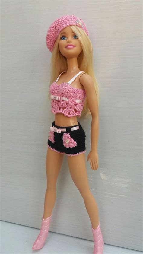 A Barbie Doll Wearing A Pink Hat And Skirt