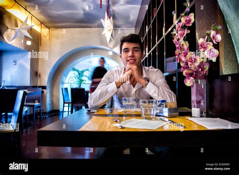 Handsome Young Man Having Lunch In Elegant Restaurant Alone Smiling And