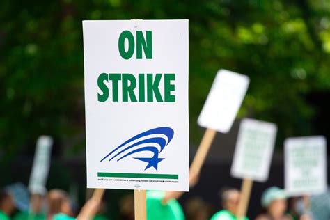 People Rallying Carrying on Strike Signage · Free Stock Photo