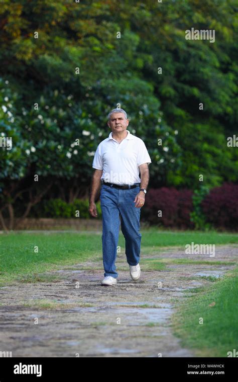 Man walking in a park Stock Photo - Alamy