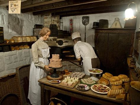 Two Bakers Are Decorating A Cake In An Old Fashioned Bread Shop With