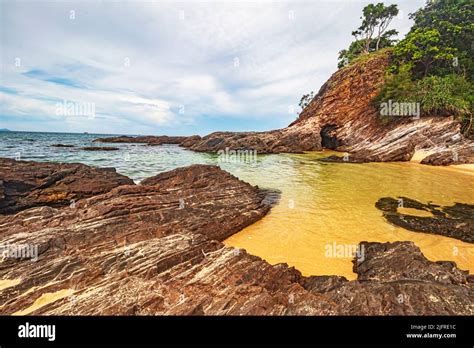 Golden Sand Beach With Rocky Outcrops At Pantai Teluk Bidara Beach In