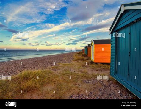 The Row Of Beautifully Vibrant Beach Huts At Findhorn In Scotland Under