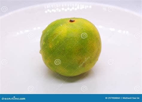 1 Orange Fruit that is Green in Color Stock Photo - Image of sweet ...