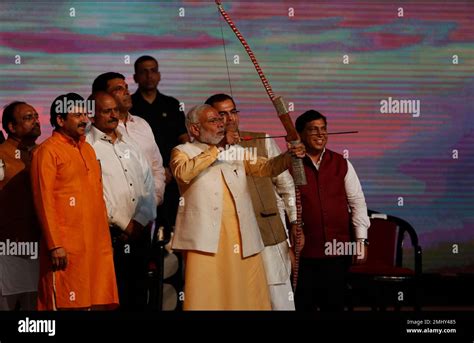 Indian Prime Minister Narendra Modi Aims An Arrow At An Effigy Of