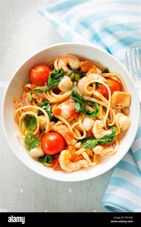 Seafood Linguine With Prawns Scallops And Salmon Spinach And Tomatoes