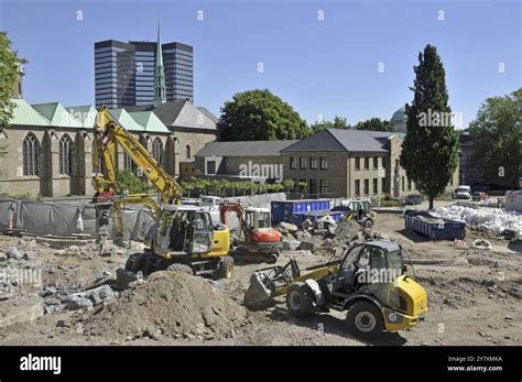Construction site in the city centre, with the town hall behind it ...
