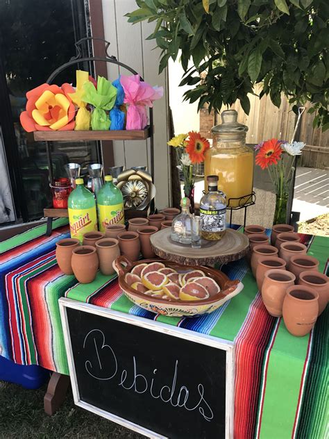 A Table Topped With Pots And Plates Filled With Food Next To A Sign