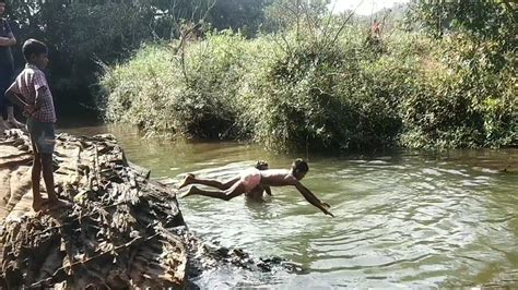 Village Boys Enjoying Jumping And Swimming In River Swimming