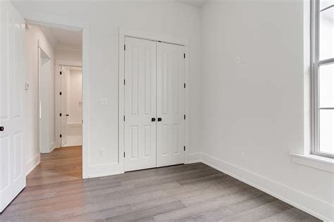 An Empty Room With White Walls And Wood Floors