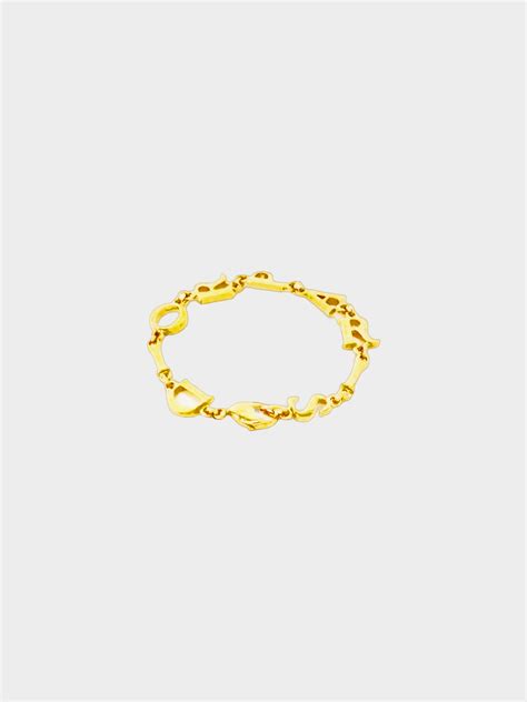 Christian Dior 1980s Gold Logo Dior Paris Spell Out Bracelet · INTO